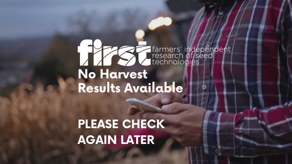 Farmer looking at a phone to check for new FIRST trials results